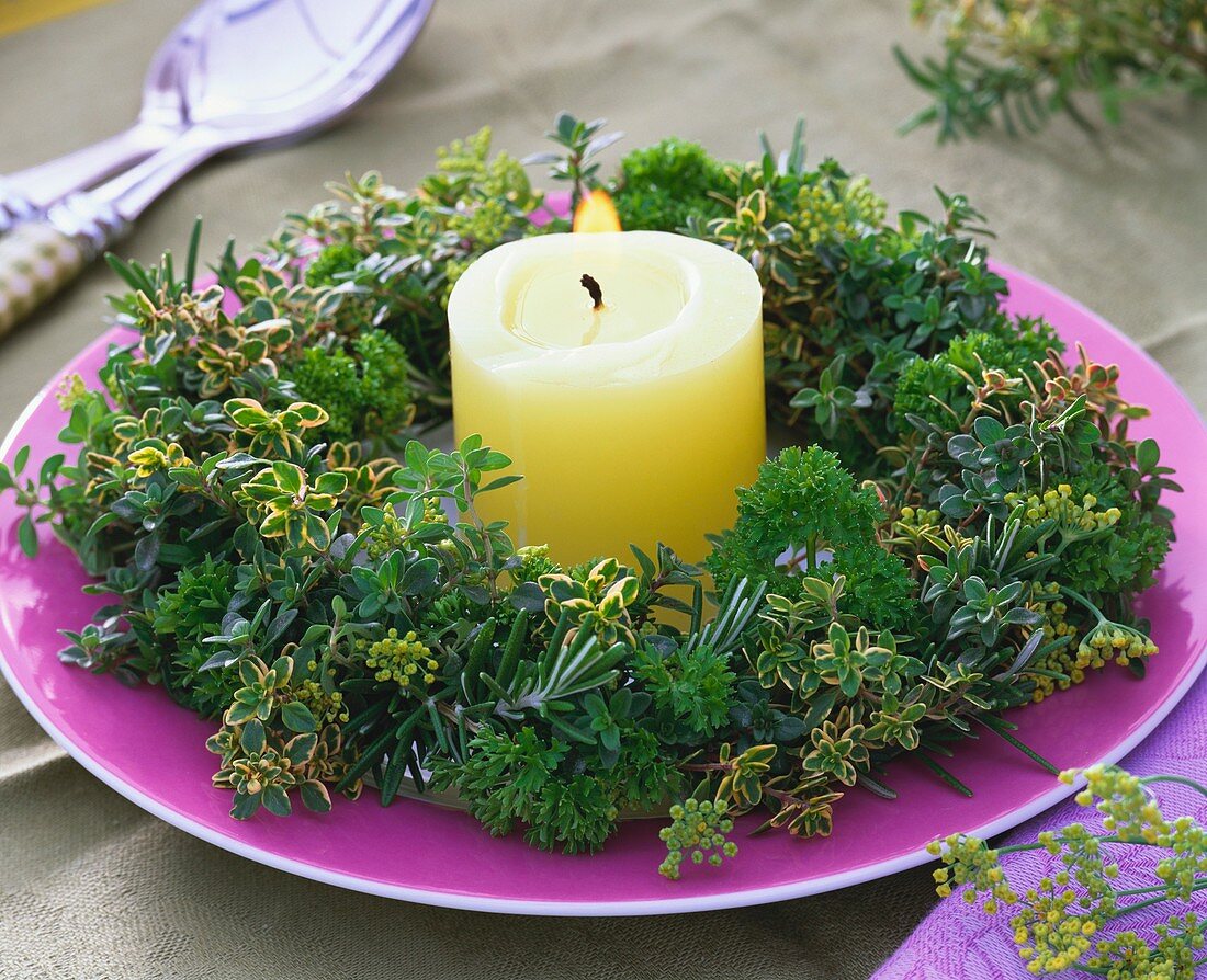Herb wreath (thyme, rosemary and parsley) around a candle