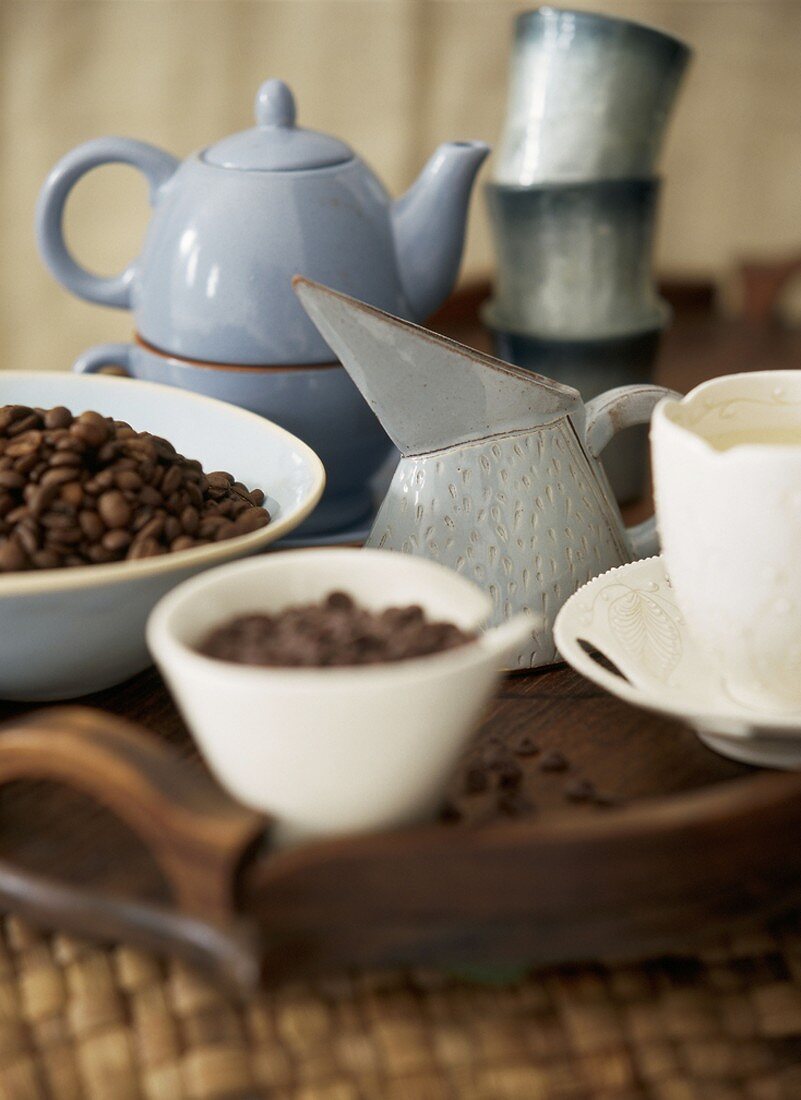 Coffee beans with a cup and a jug