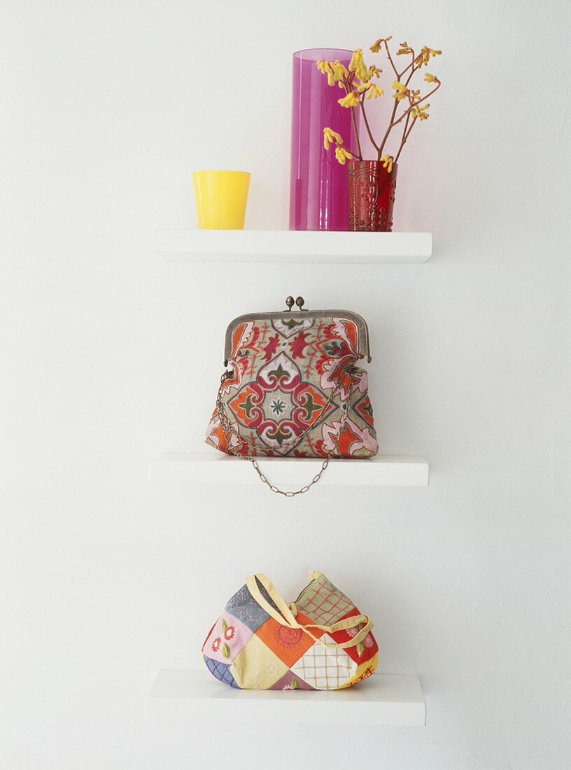 Handbags and vases on three shelves