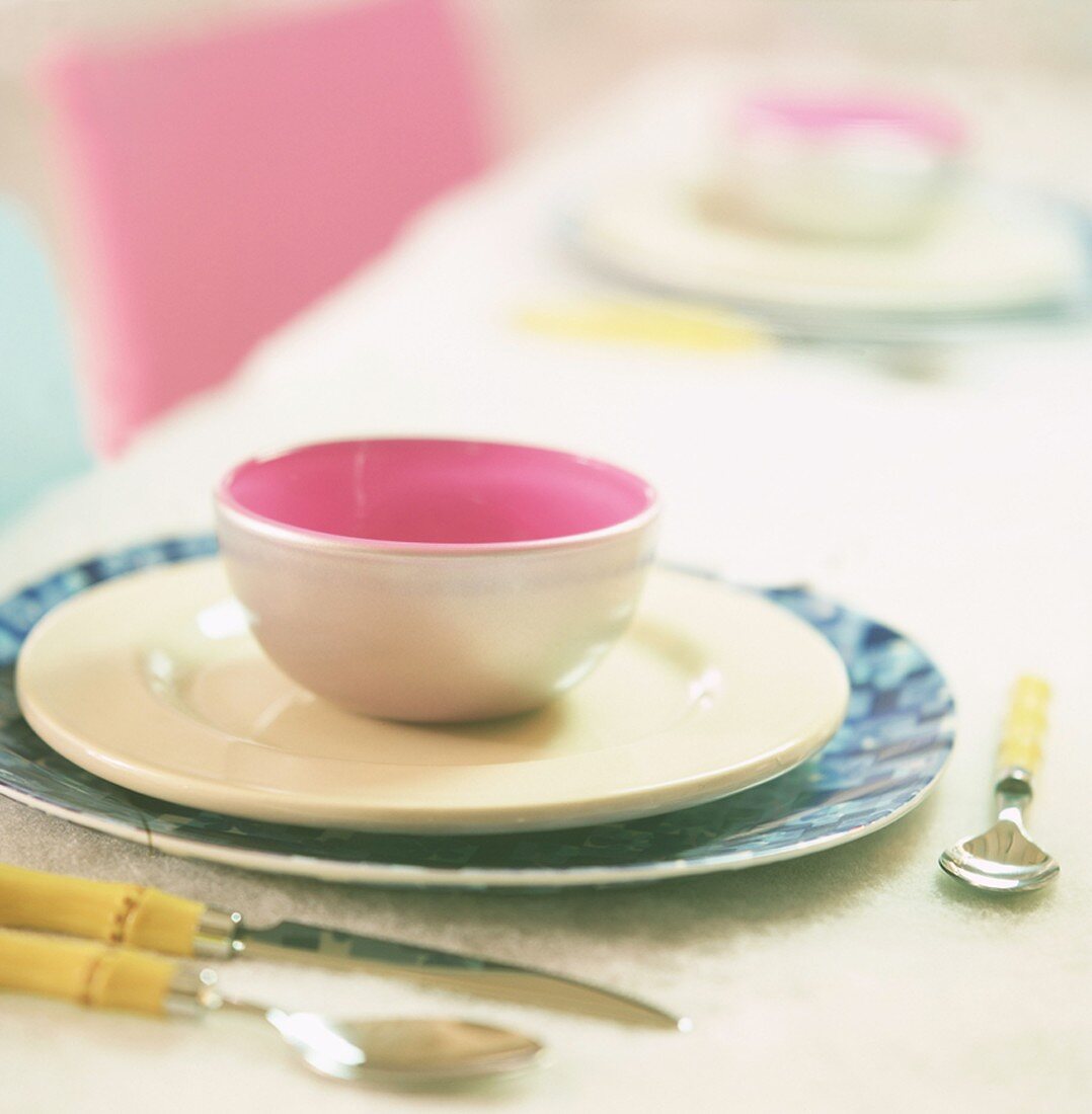 A place-setting with cup and plates