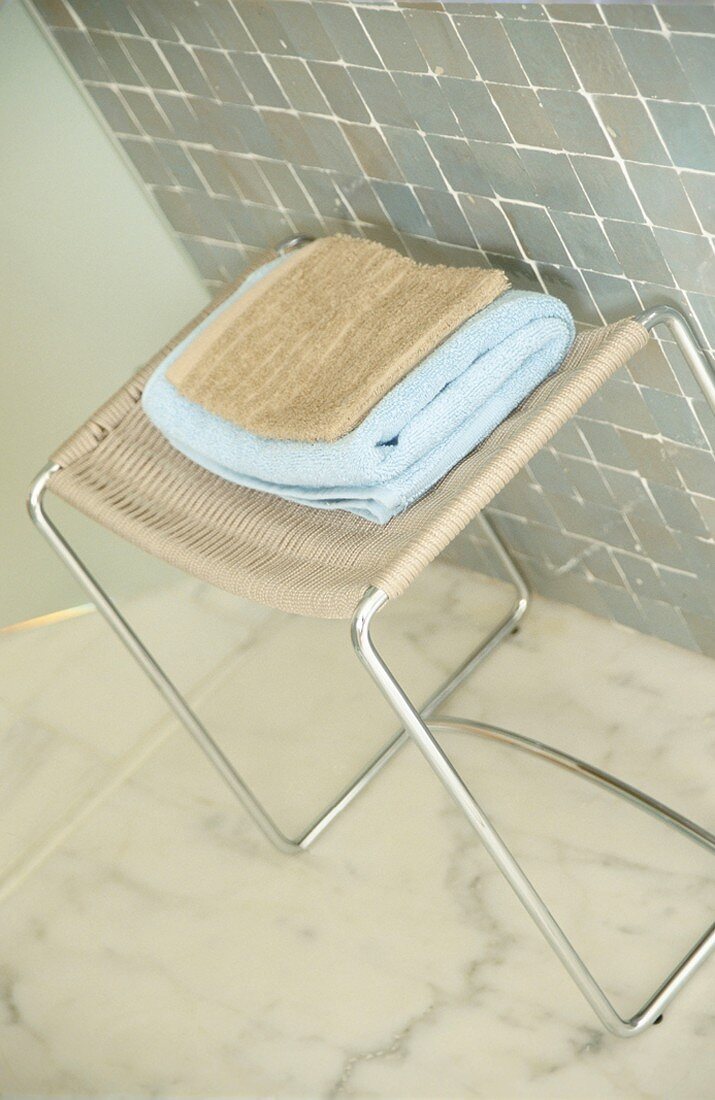 Facecloth and bath towel on a stool
