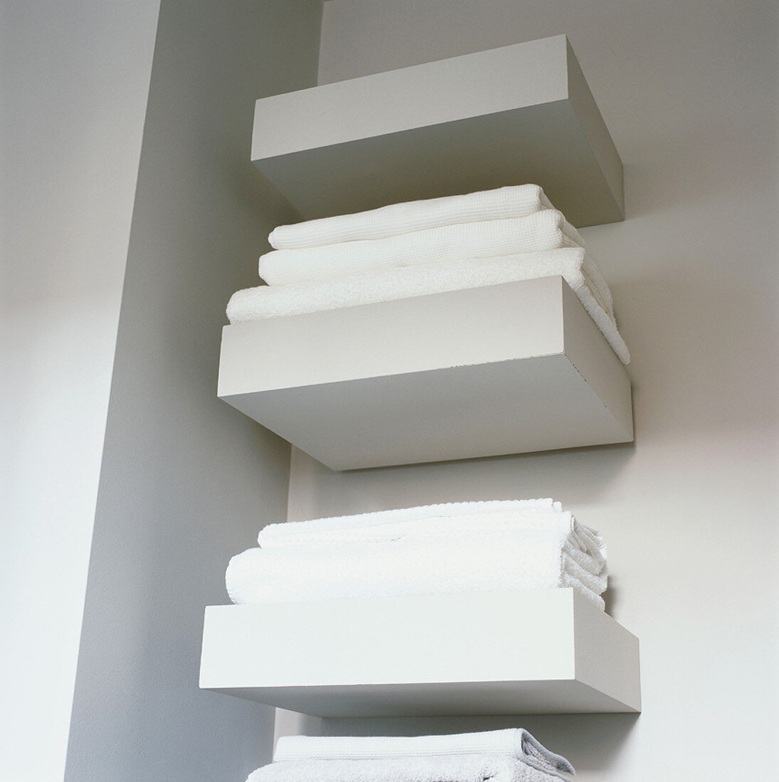White bath towels on shelves