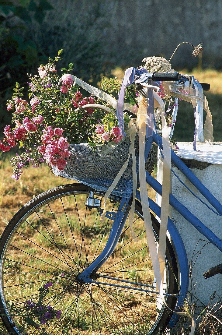 A bicycle with a basket filled with flowers