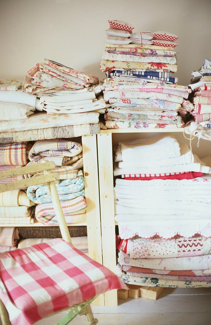 Linen stacked on simple wooden shelves