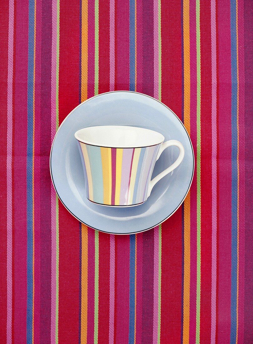 Striped cup on striped tablecloth