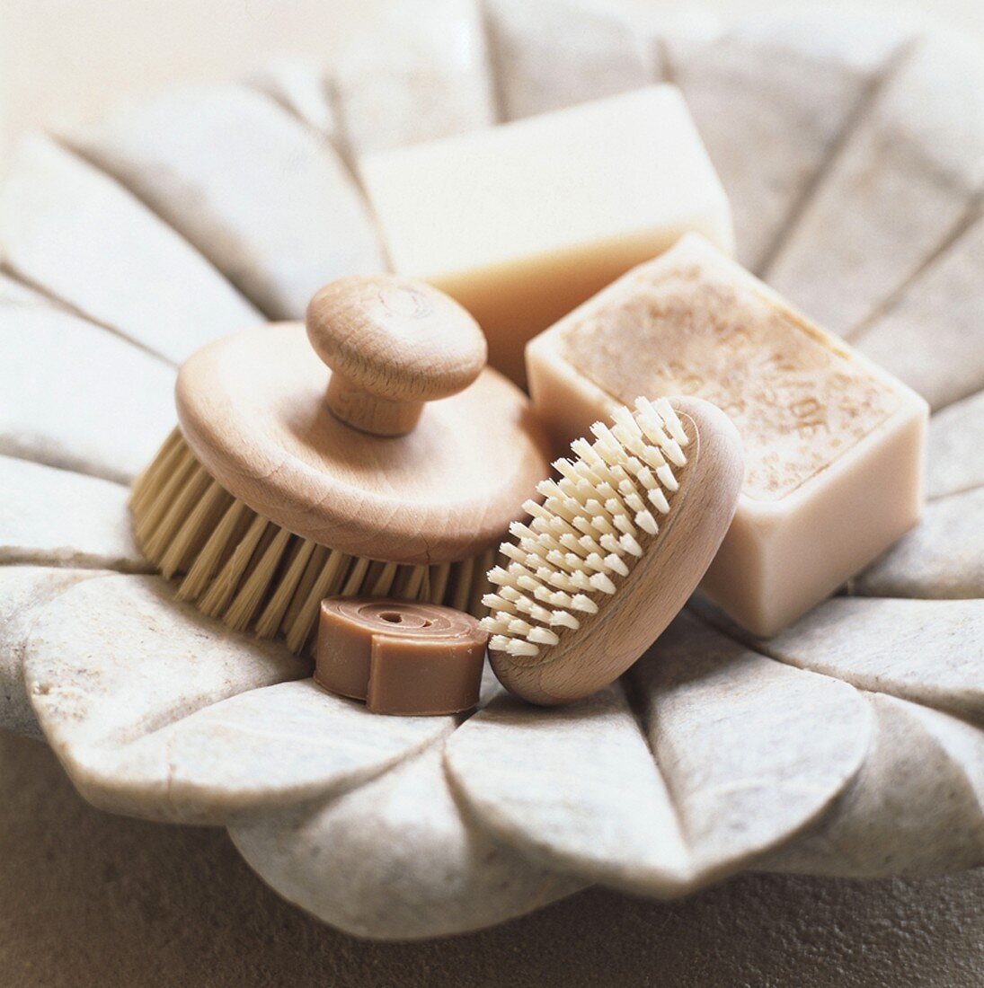 Various soaps & brushes in dish