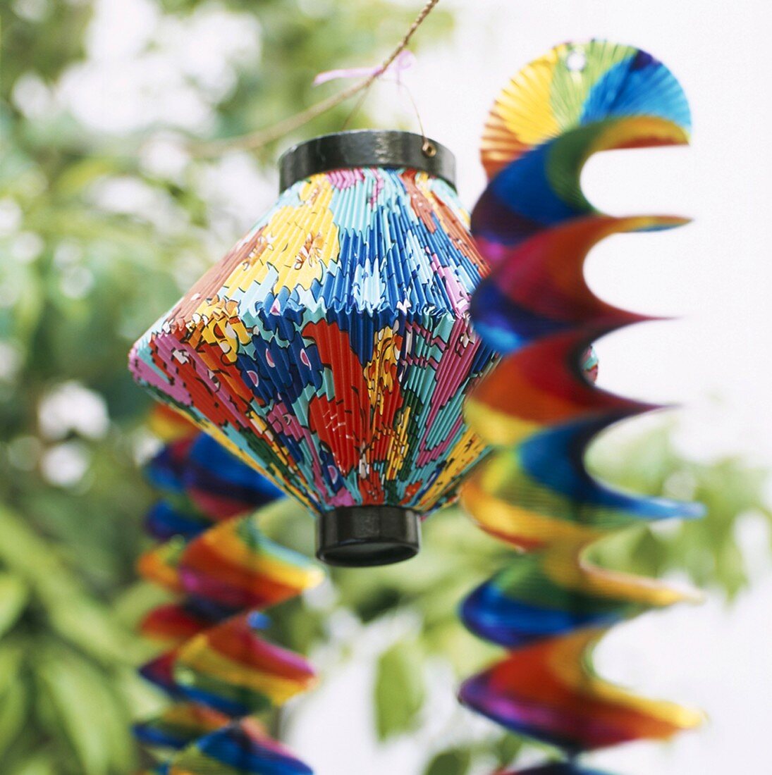 Lanterns and paper decorations hanging from cord