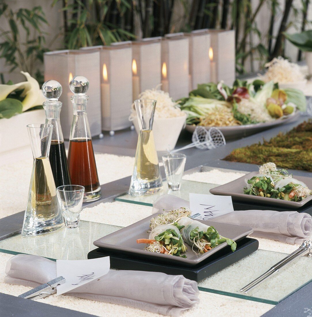 An oriental-style table laid with rice paper rolls