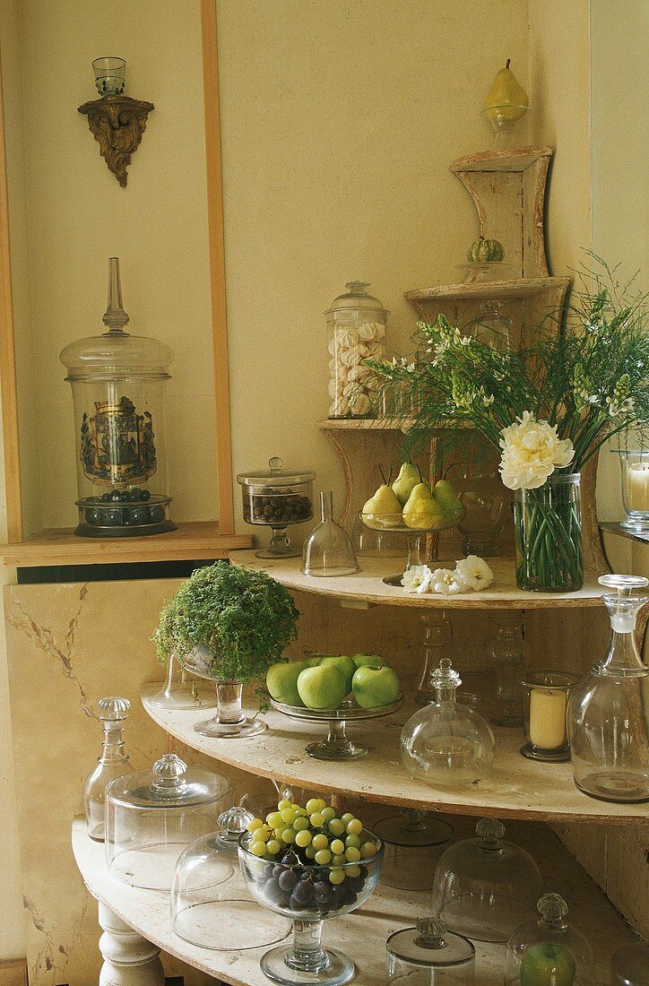 A corner shelf with fruit and flowers in a dining room