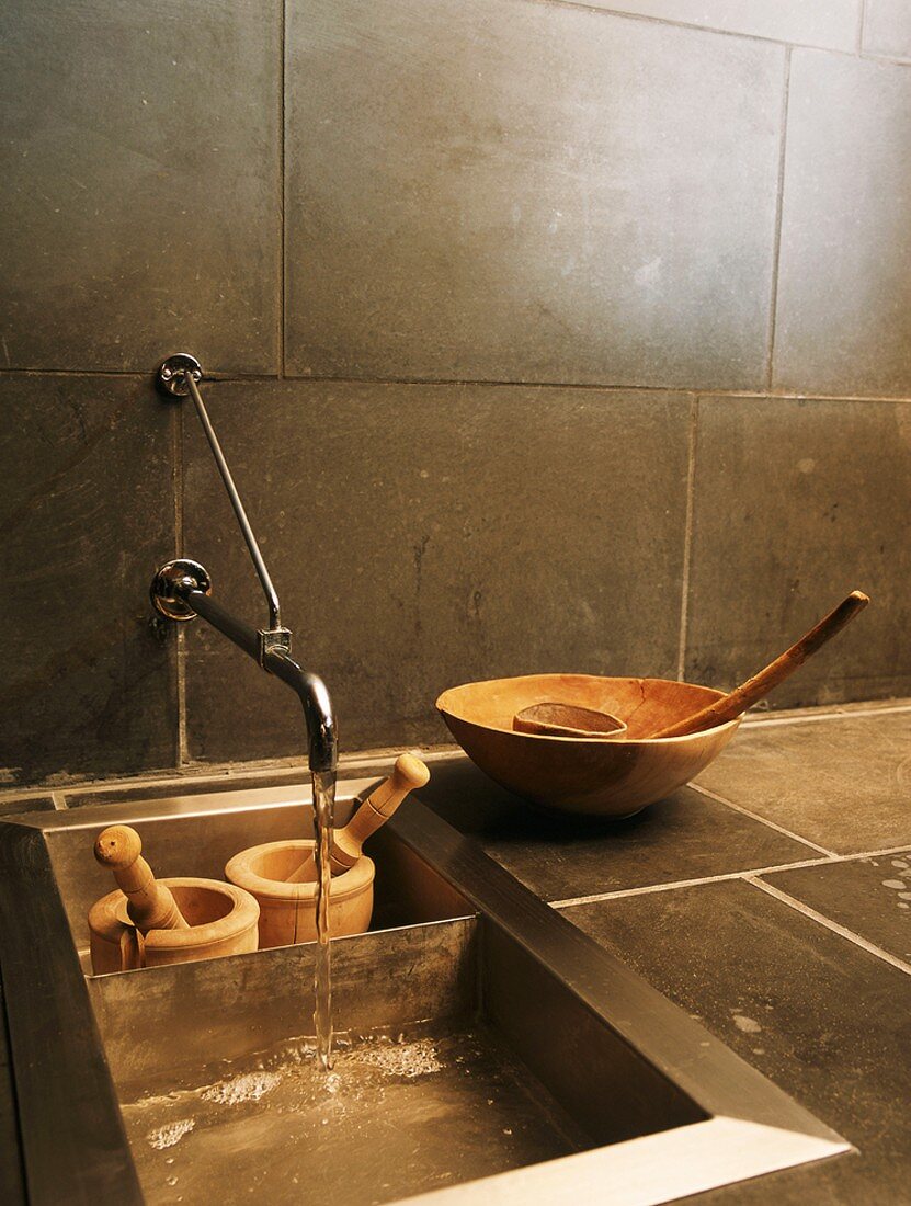 Wooden bowls & two wooden mortar and pestle sets in sink