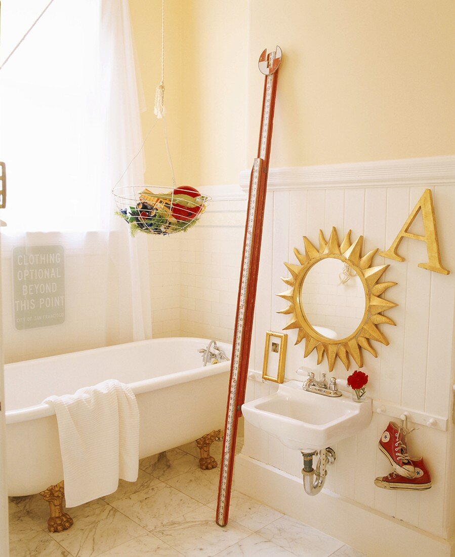 Traditional bathroom with free-standing bathtub and gilt accessories