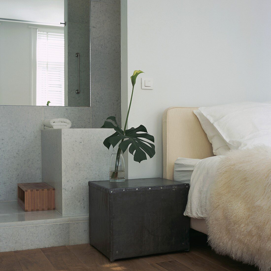 Detail of bedroom with view into bathroom