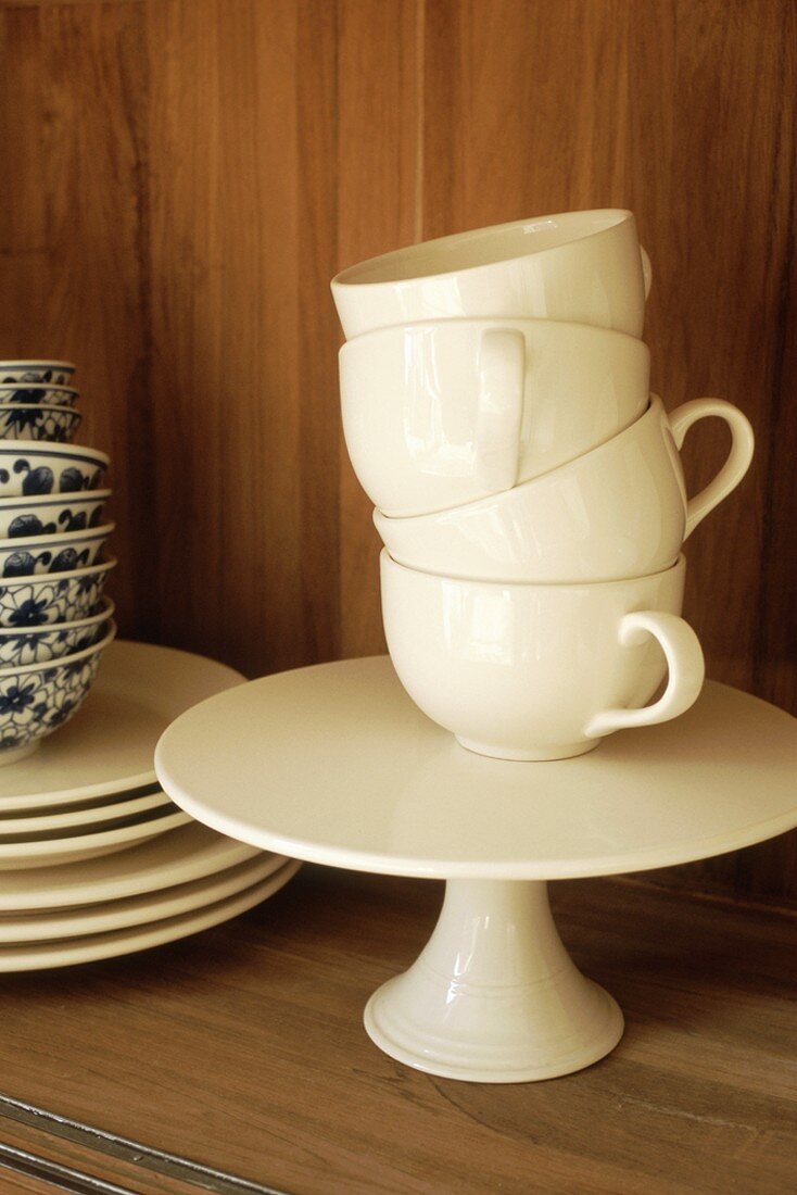 Stacked crockery in cupboard