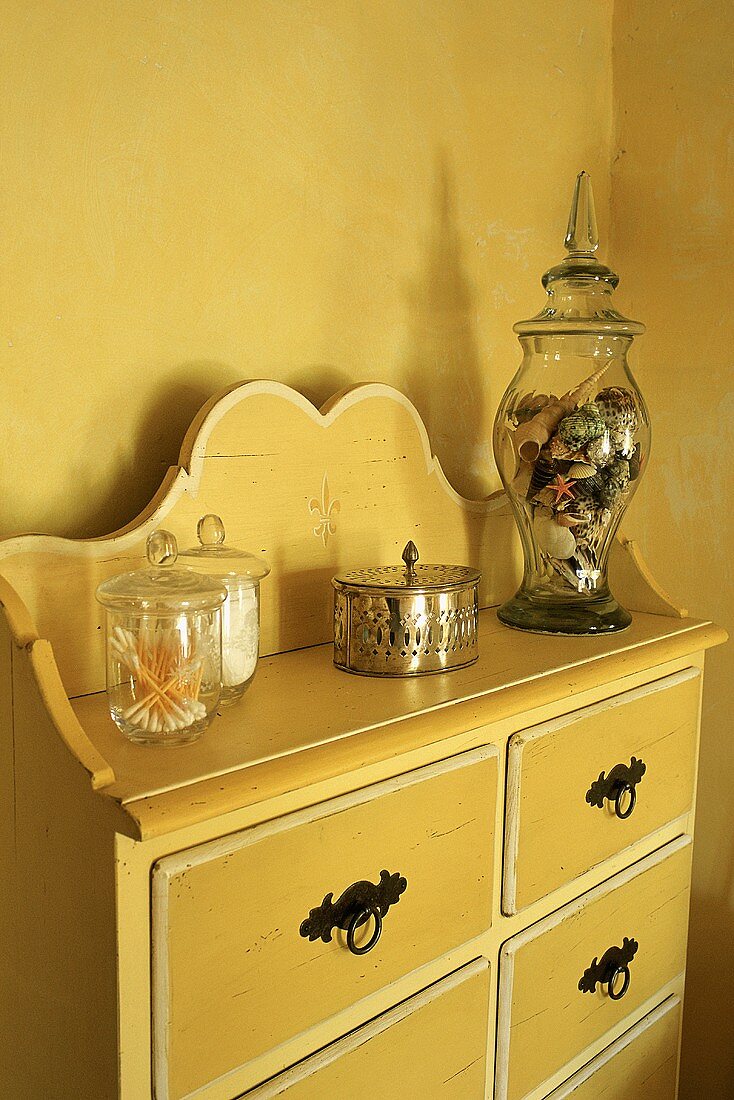 A chest of drawers with curved backboard