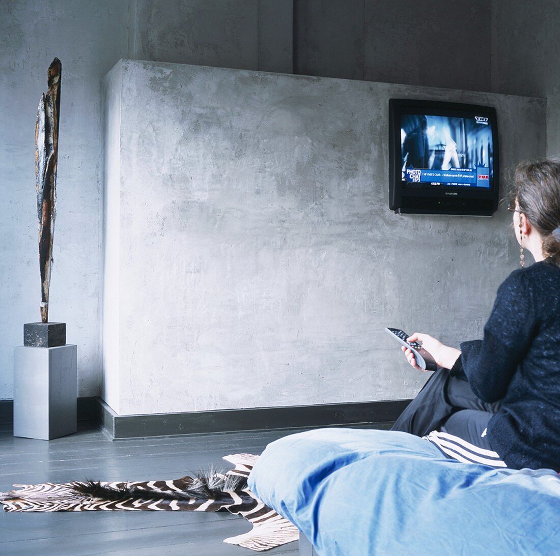 Woman watching TV in bedroom