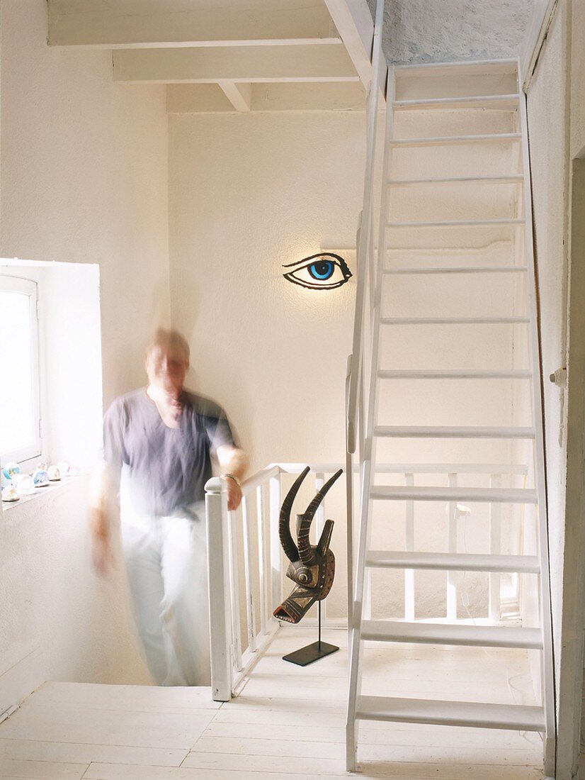 Man walking up stairs in house