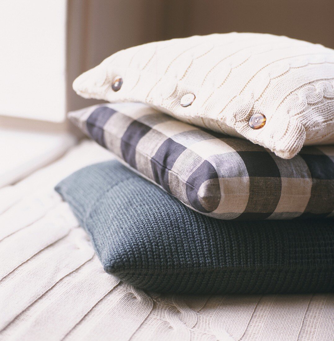 Stack of three different scatter cushions