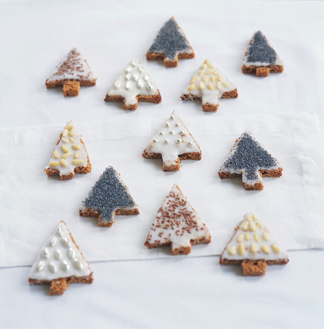 Various decorated Christmas tree biscuits with icing sugar