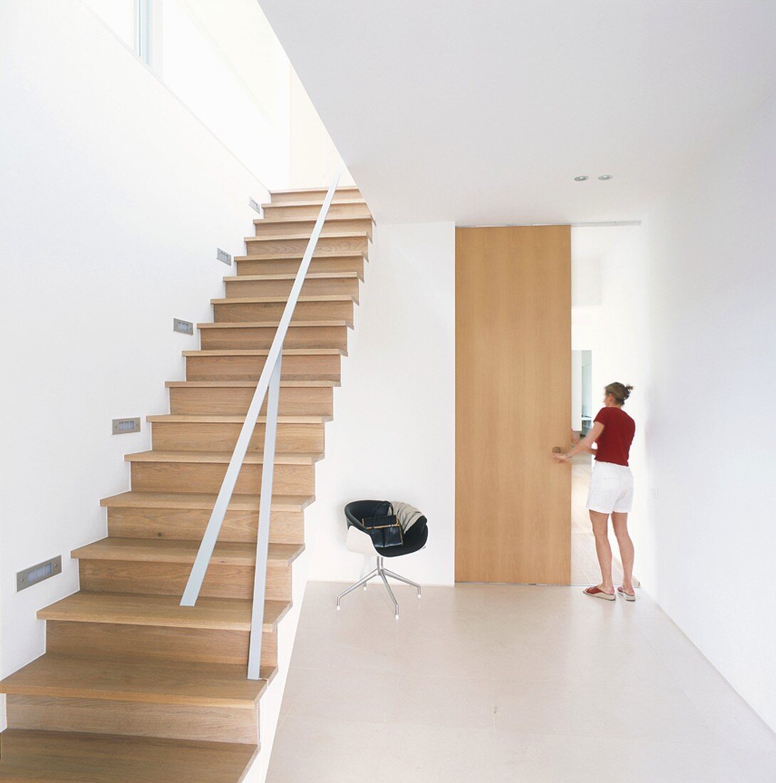 Woman opening door in stairwell