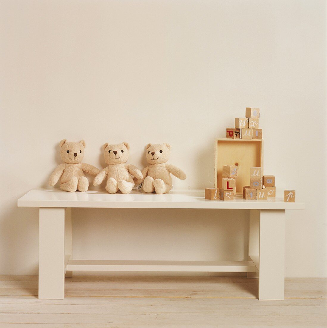 Teddy bears and toys on a bench