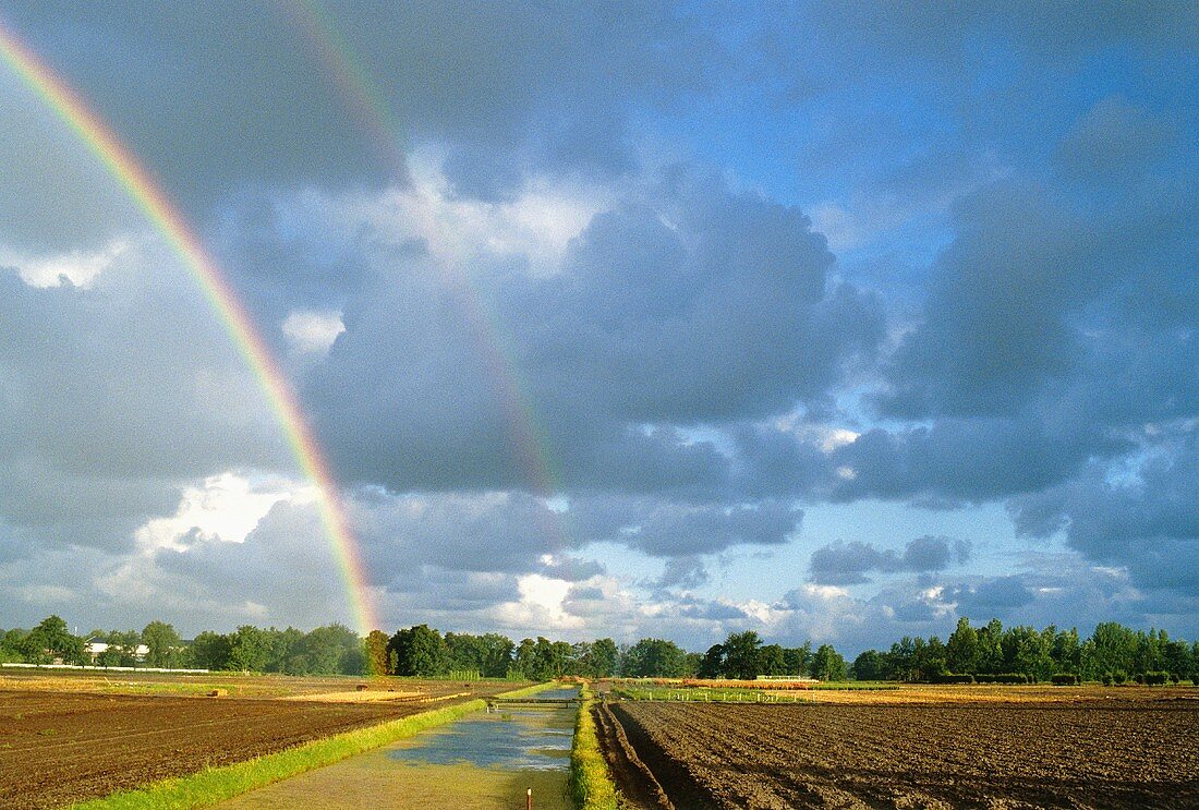 Double rainbow over arable land
