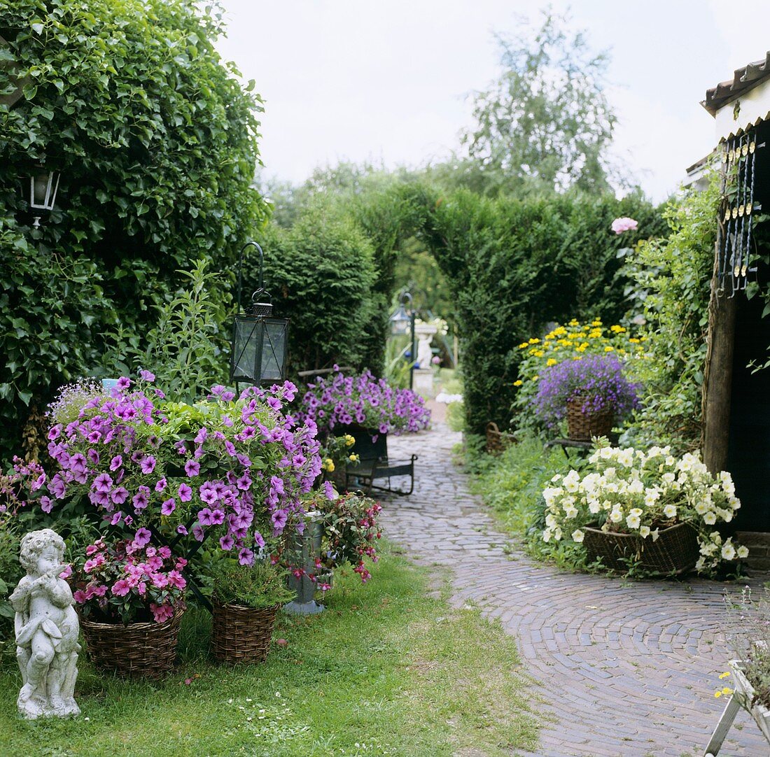 Summer garden with flowers and garden ornaments