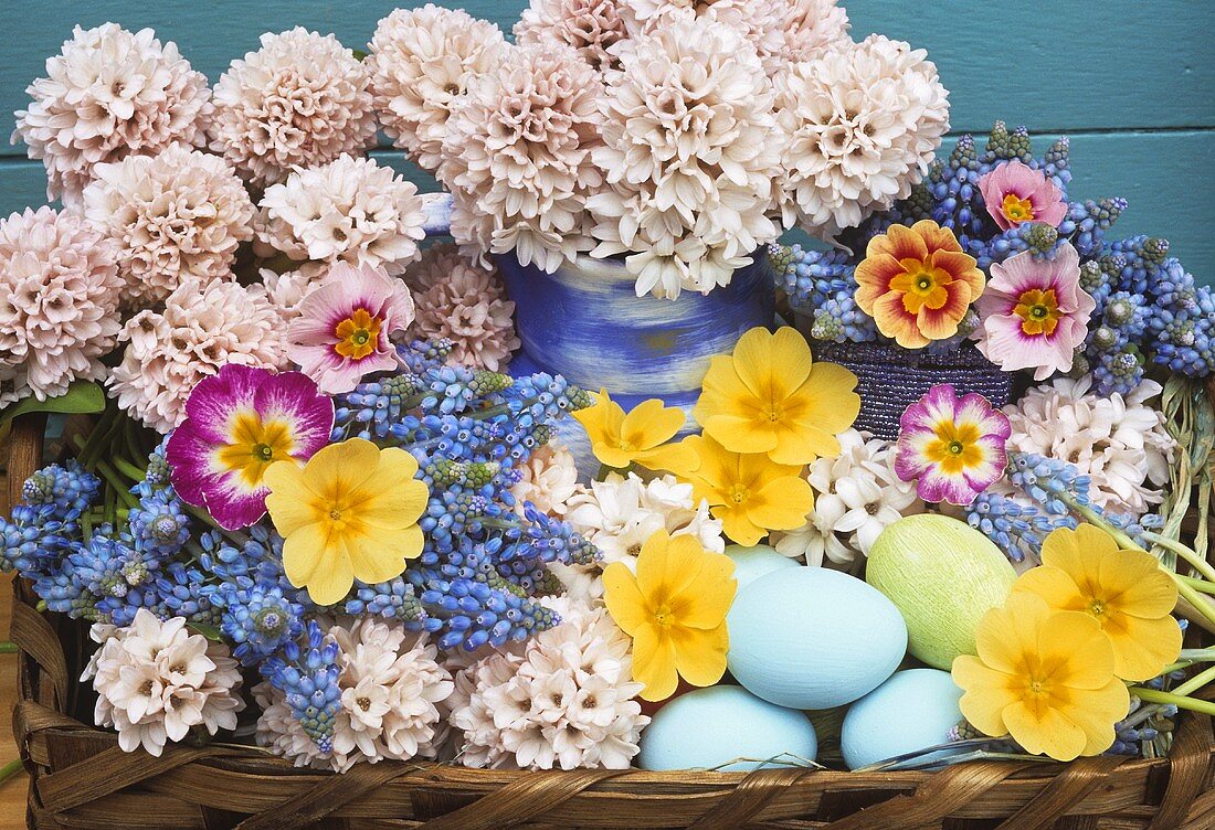 Spring flowers and Easter eggs in a basket