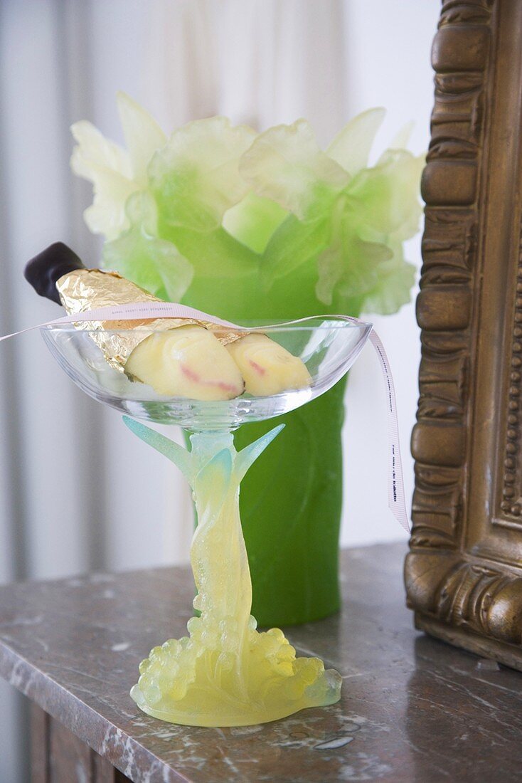 Arrangement in glass goblet and ornate candle