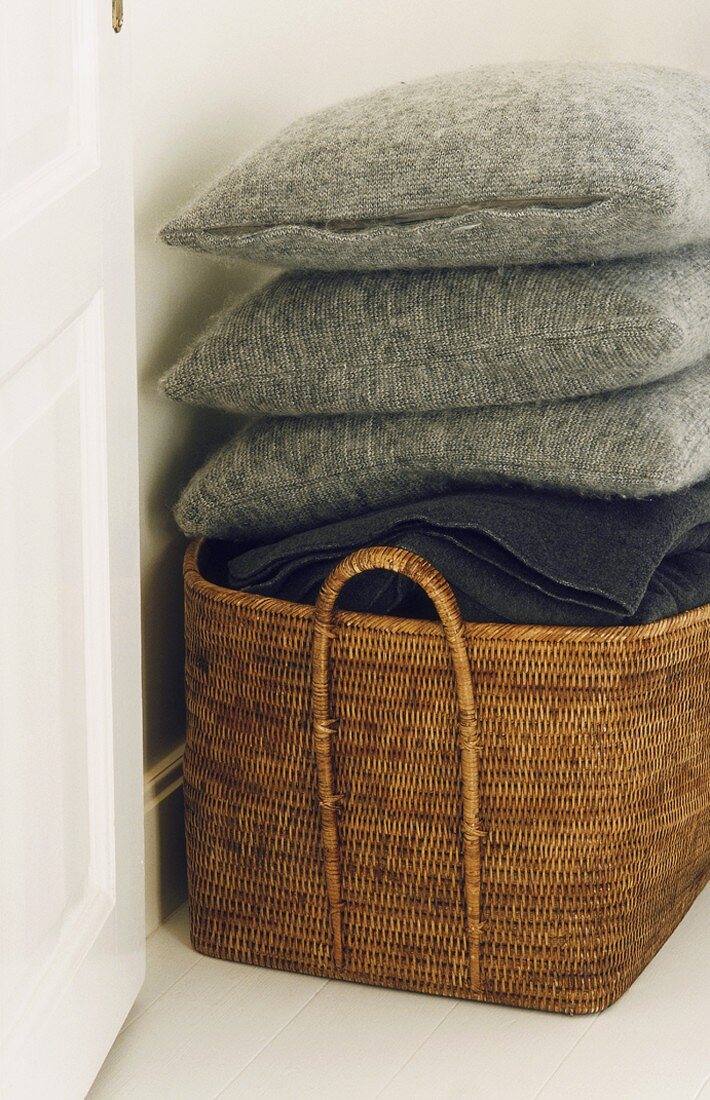 Cushions and blanket in basket