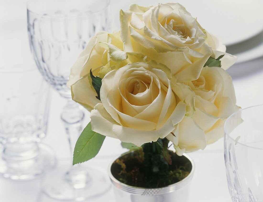 Posy of white roses on laid table