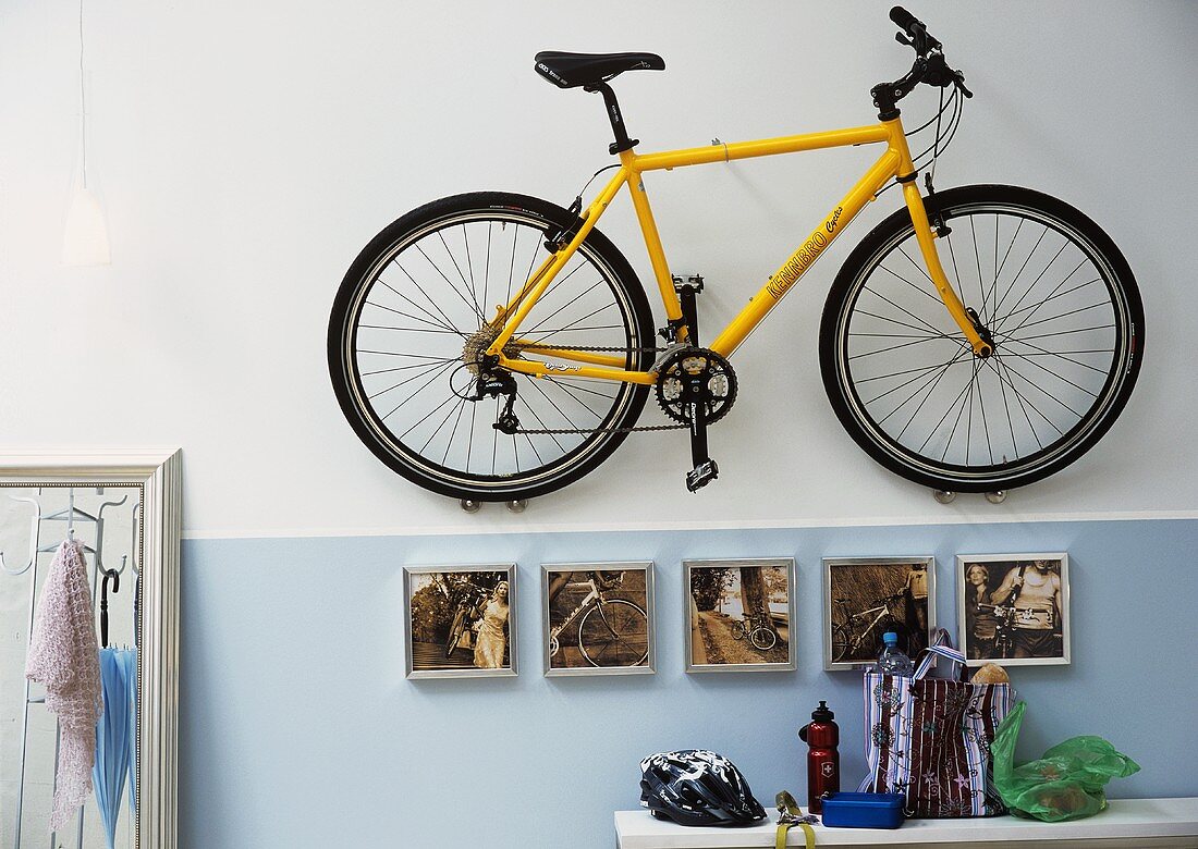Bicycle hanging on wall in hall