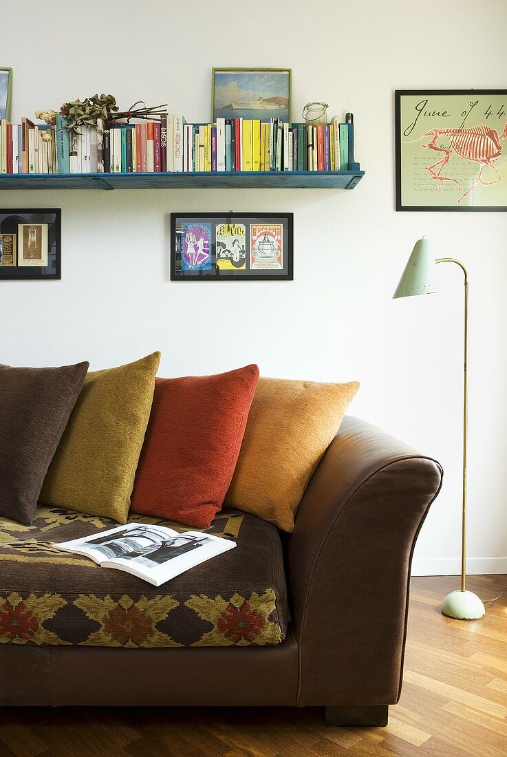 Leather sofa with colored pillows and fifties style floor lamp