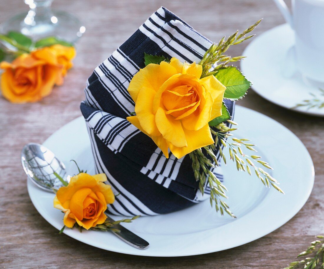 Napkin decorated with yellow rose and grasses