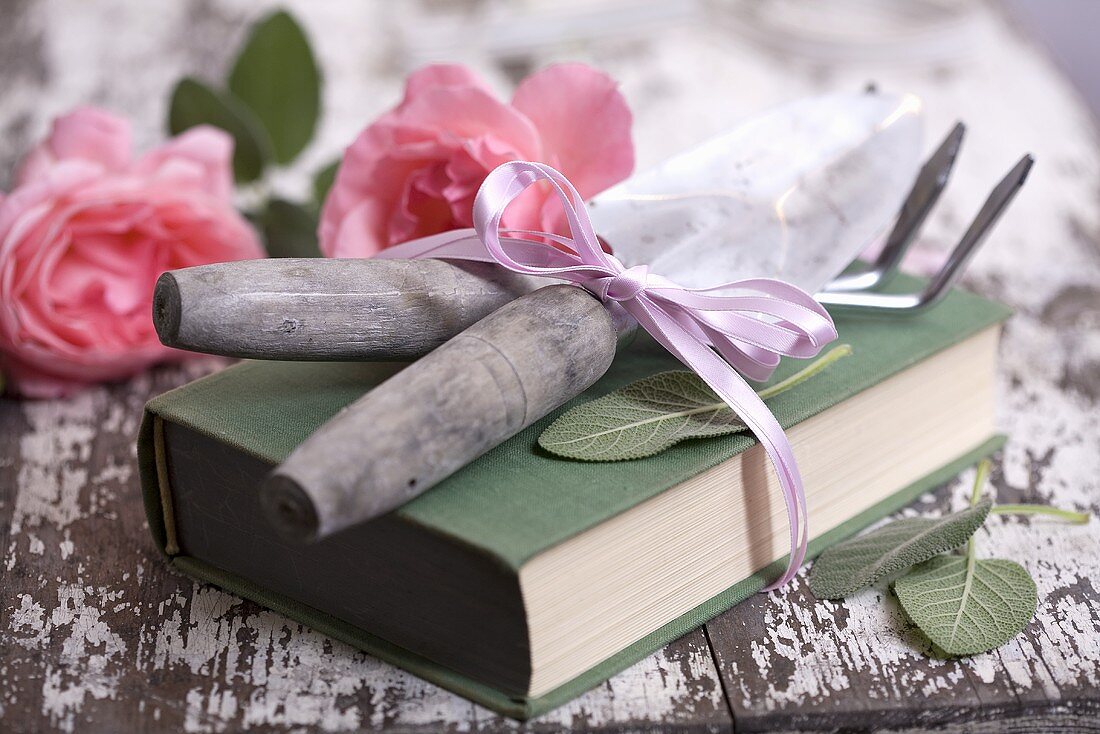 Garden tools, book and roses