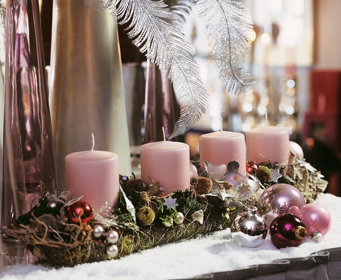 Advent arrangement with four pink pillar candles