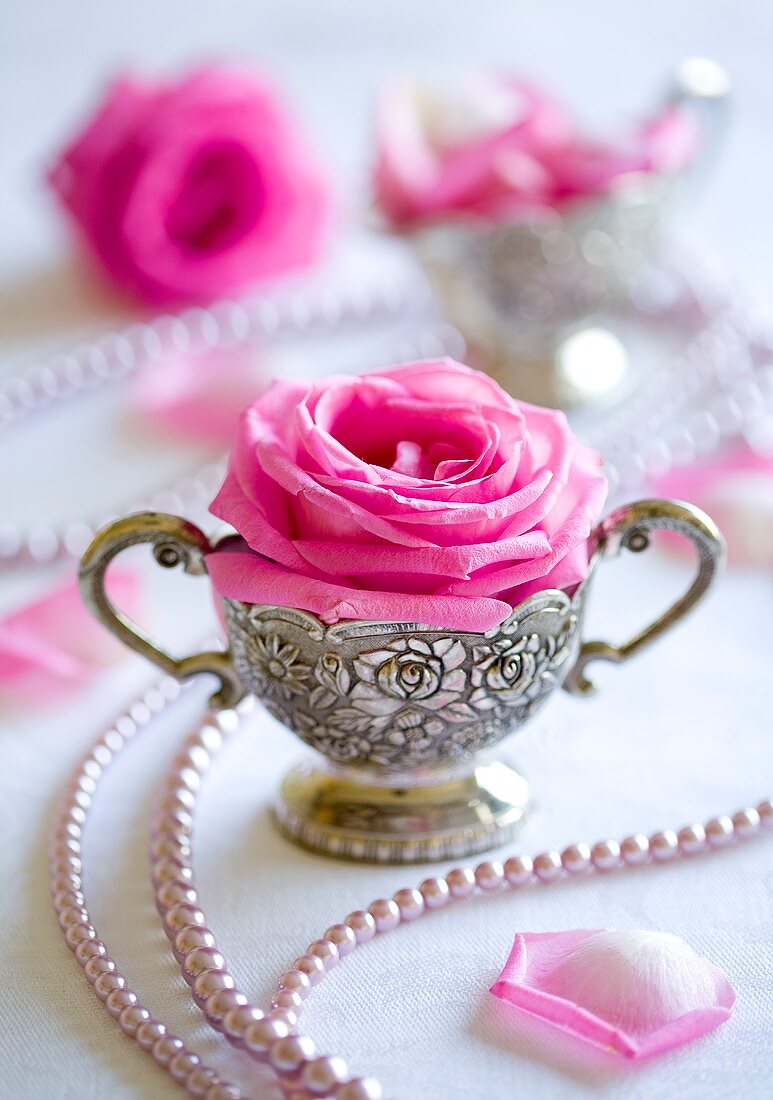 Festliche Tischdekoration mit Rosen und Perlen