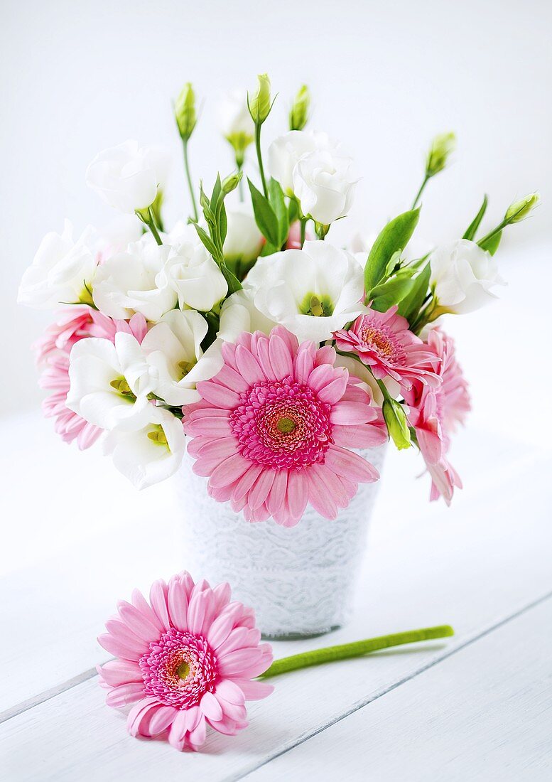 A bunch of flowers on a white wooden table