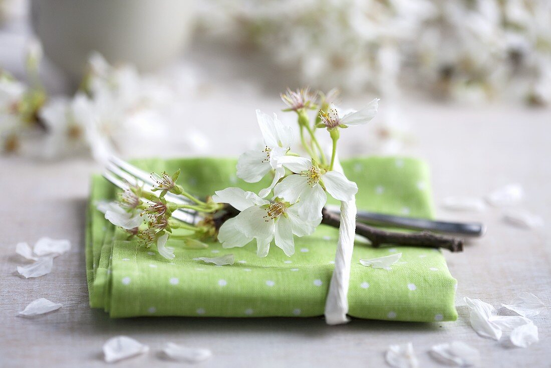 A napkin decorated with a sprig of cherry blossom