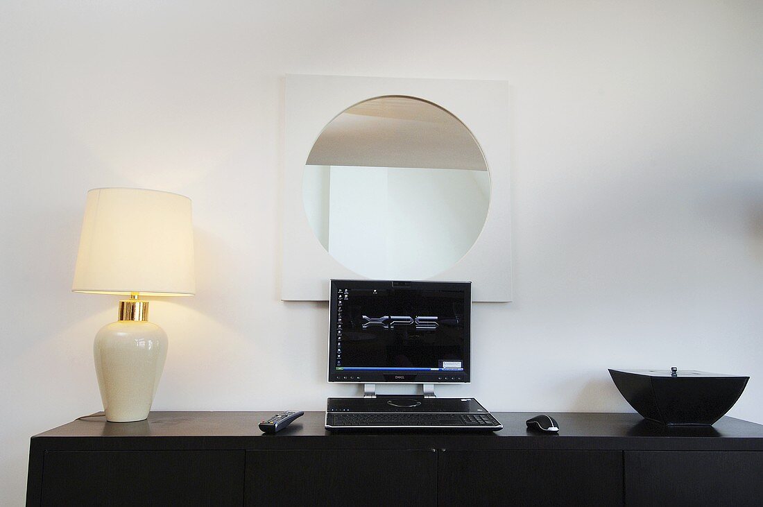 Table lamp and computer on a sideboard