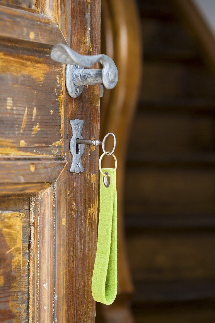Key in the lock of a rustic house door