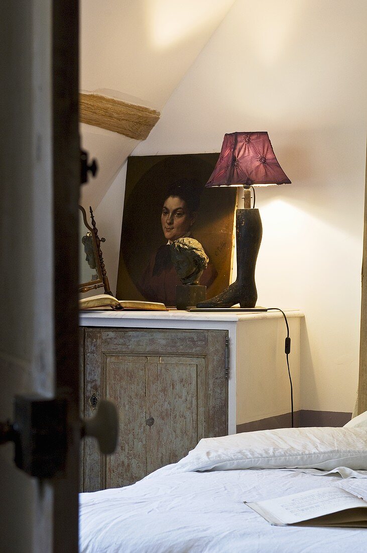 Picture, lamp and book on bedside table