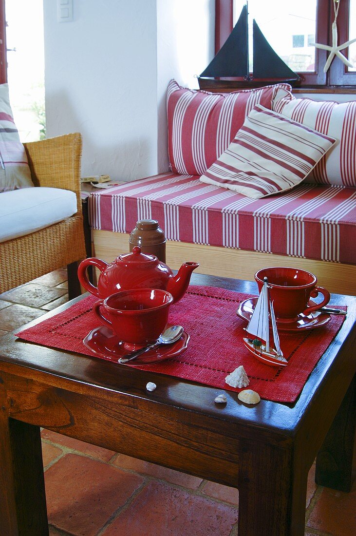 Tea things and maritime decorations on coffee table