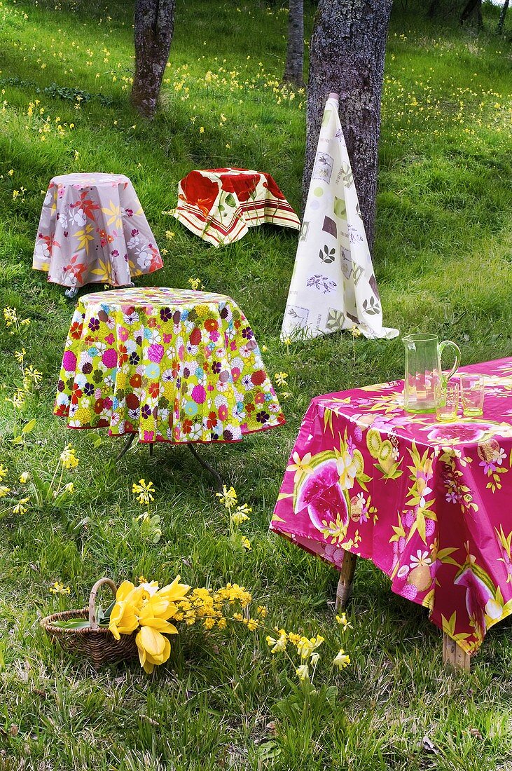 Tables with coloured tablecloths out of doors