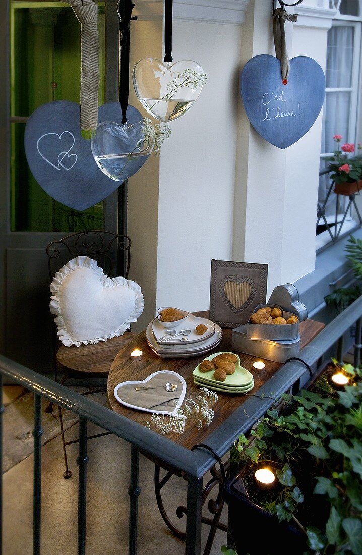 Balcony decorated with hearts, tealights and biscuits