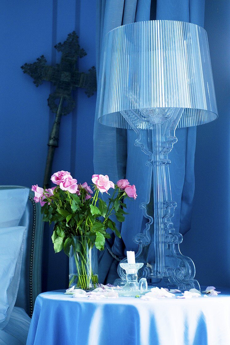 Lamp and roses on occasional table in Château de la Verrerie, France