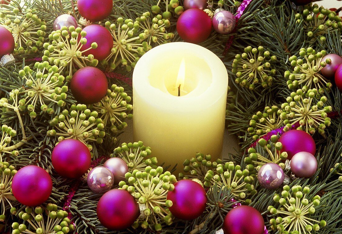 A burning candle in a wreath