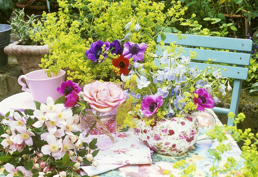 Table decoration of anemones and delphiniums in a teapot