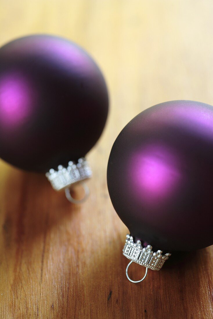 Two purple Christmas baubles