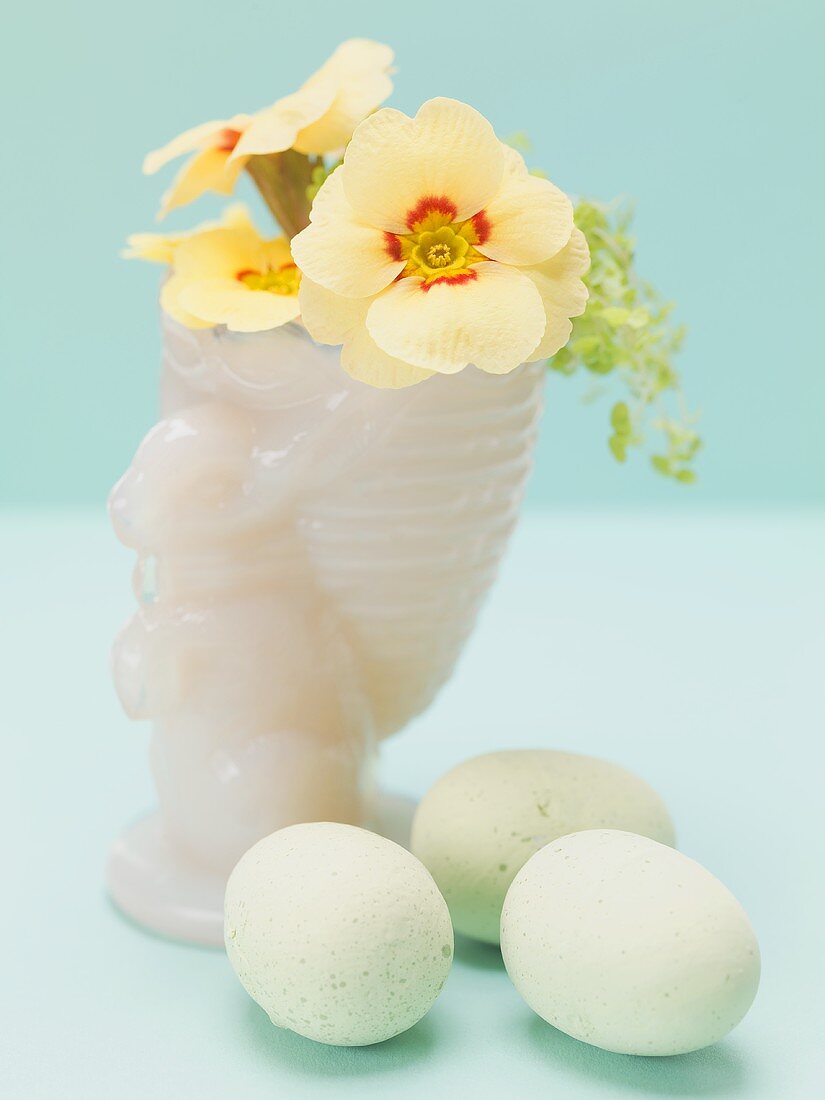 Primroses in Easter vase, eggs