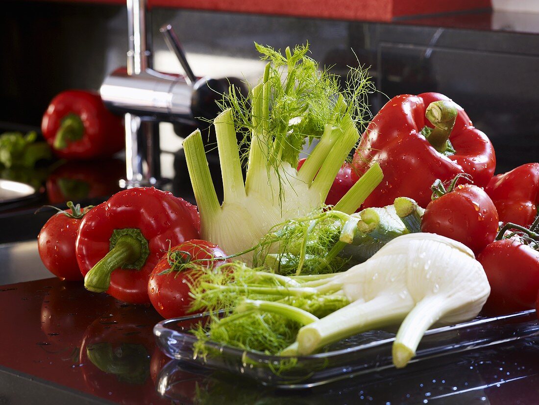 Fennel, tomatoes, peppers on worktop in kitchen